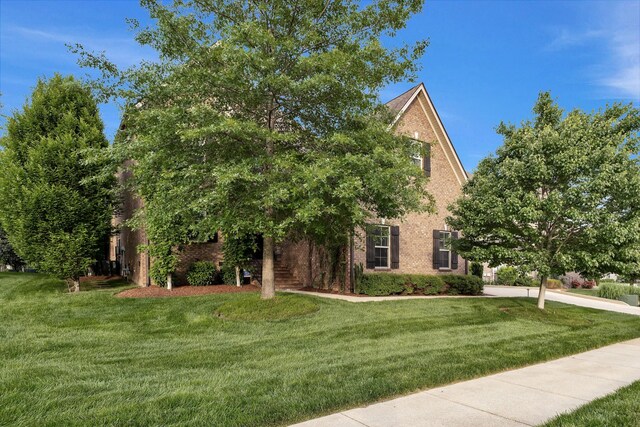 6018 Trotwood Ln, Spring Hill, TN 37174 - view of property hidden behind natural elements featuring brick siding and a front lawn