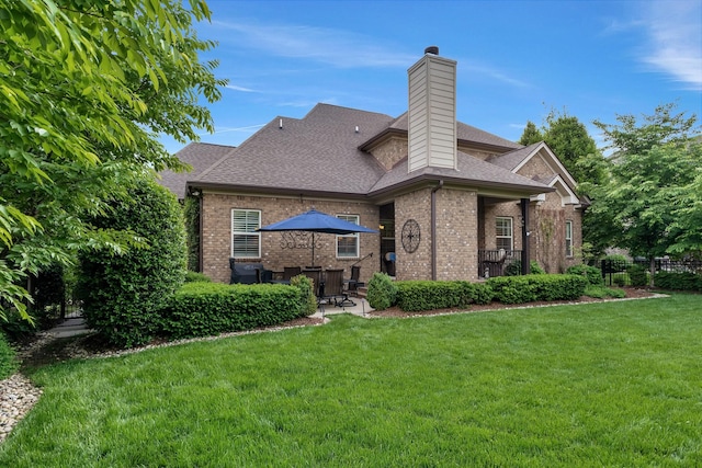 6018 Trotwood Ln, Spring Hill, TN 37174 - back of property featuring brick siding, a lawn, a patio area, and roof with shingles