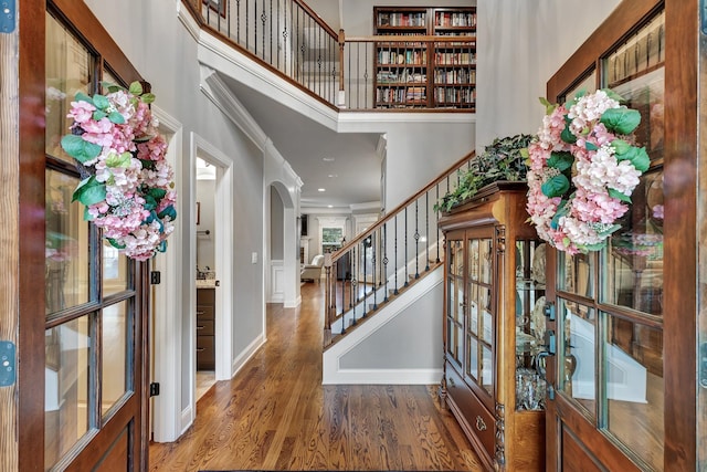 6018 Trotwood Ln, Spring Hill, TN 37174 - foyer with wood finished floors, a towering ceiling, arched walkways, stairs, and baseboards
