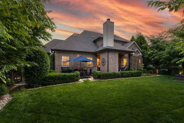 6018 Trotwood Ln, Spring Hill, TN 37174 - back of property featuring brick siding, a chimney, a lawn, and roof with shingles