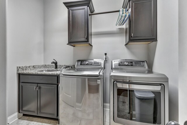 6018 Trotwood Ln, Spring Hill, TN 37174 - washroom with cabinet space, separate washer and dryer, and baseboards