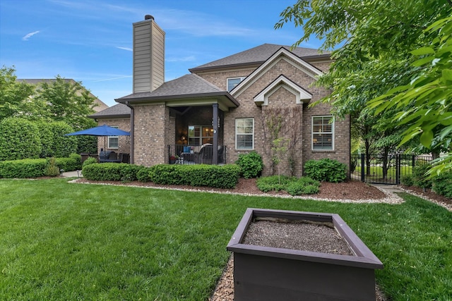 6018 Trotwood Ln, Spring Hill, TN 37174 - back of house with a chimney, brick siding, and roof with shingles