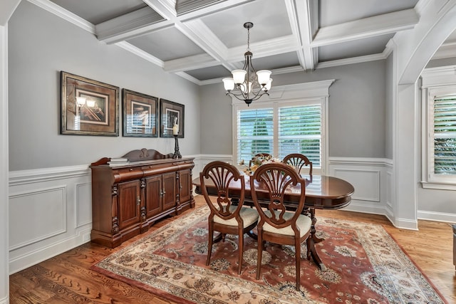6018 Trotwood Ln, Spring Hill, TN 37174 - dining area with light wood finished floors, a chandelier, beam ceiling, coffered ceiling, and arched walkways
