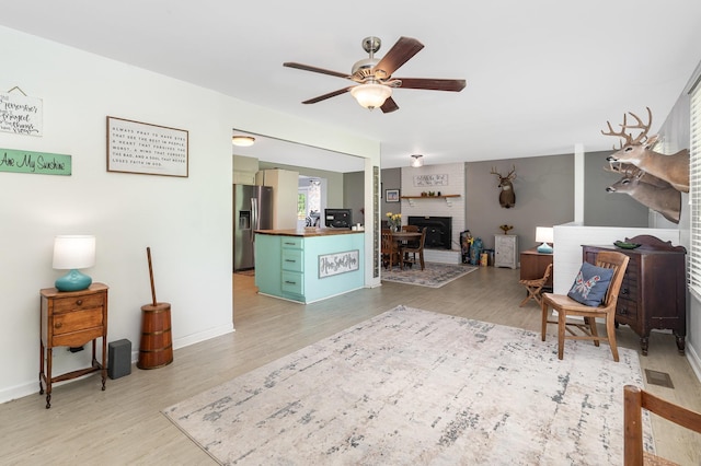 247 High Cliff Dr, Hendersonville, TN 37075 - living room featuring a ceiling fan, light wood finished floors, and a fireplace