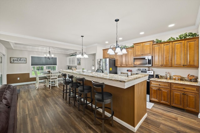 5004 Curtis Way, Cookeville, TN 38506 - kitchen featuring appliances with stainless steel finishes, a chandelier, brown cabinetry, dark wood-style floors, and recessed lighting