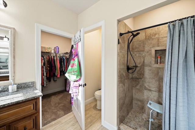 5004 Curtis Way, Cookeville, TN 38506 - bathroom with a shower stall, toilet, a spacious closet, vanity, and baseboards