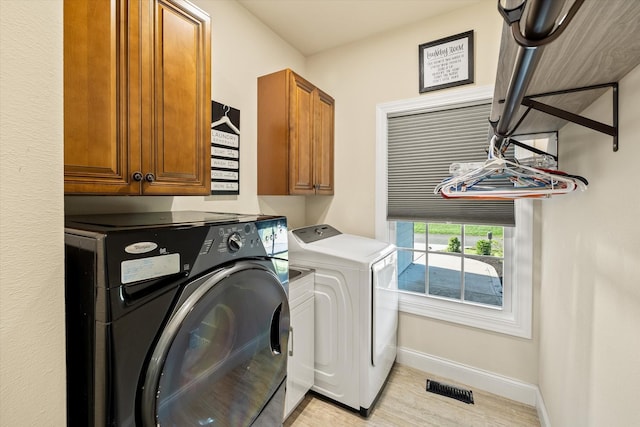5004 Curtis Way, Cookeville, TN 38506 - washroom with washer and dryer, cabinet space, baseboards, and light wood-style flooring