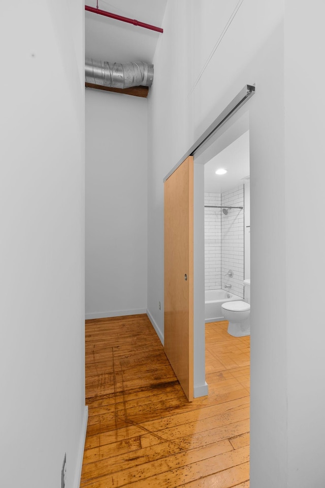 hall with hardwood / wood-style floors