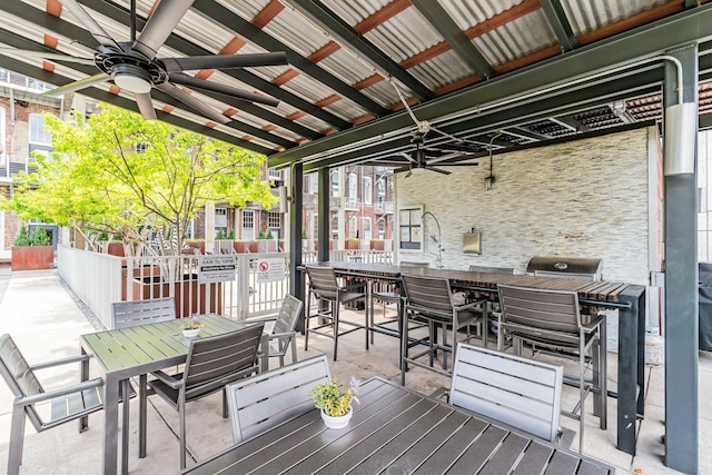 wooden deck featuring outdoor dining area and a ceiling fan
