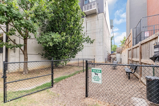 view of property's community featuring fence and a gate