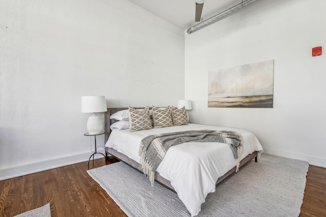 bedroom with wood finished floors and baseboards