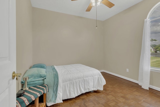 bedroom featuring baseboards and ceiling fan