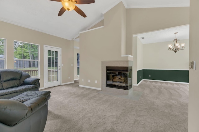 living area featuring carpet, ornamental molding, ceiling fan, a chandelier, and baseboards