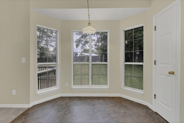unfurnished dining area featuring baseboards