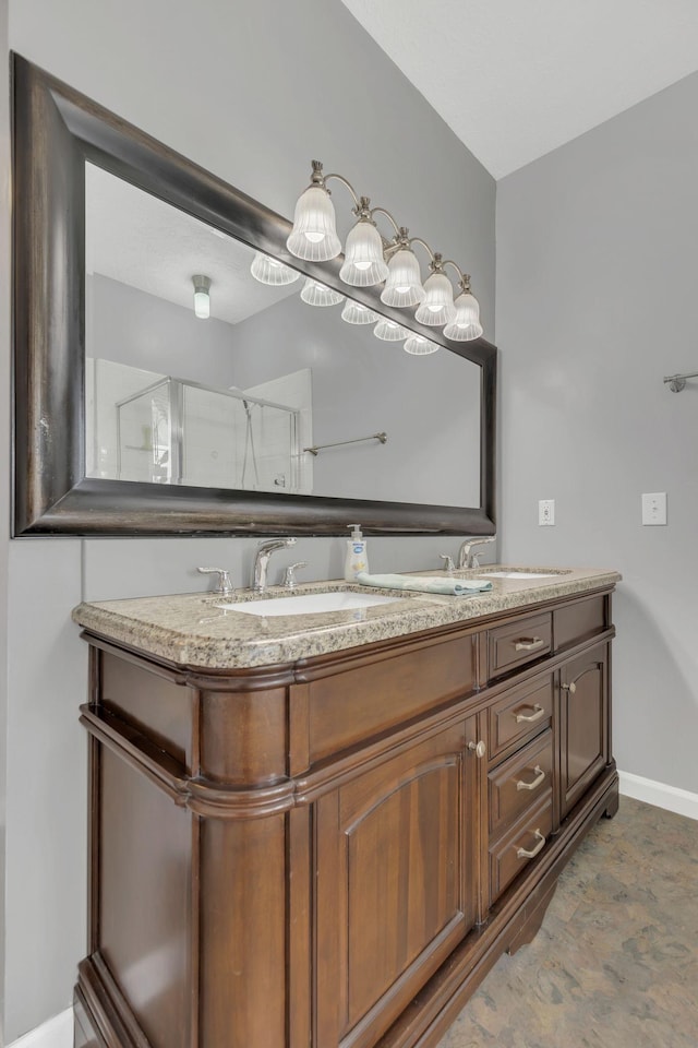 full bathroom with baseboards and double vanity