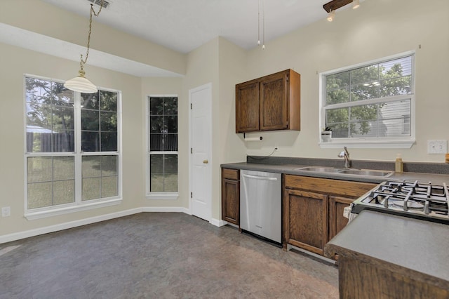 kitchen with stainless steel dishwasher, a sink, plenty of natural light, and decorative light fixtures