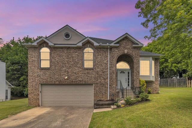 view of front of house featuring an attached garage, driveway, and brick siding