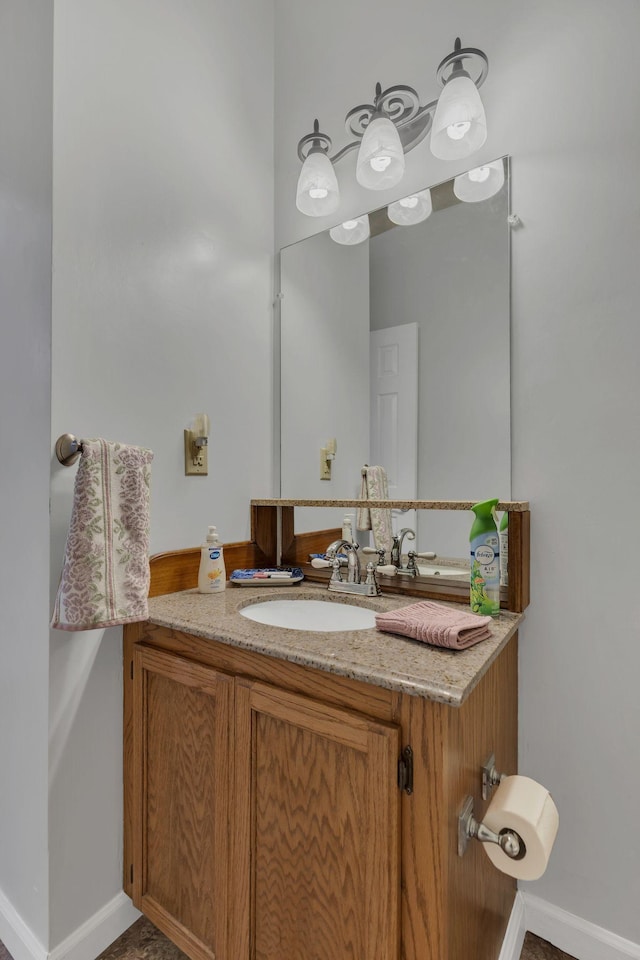 bathroom featuring baseboards and vanity