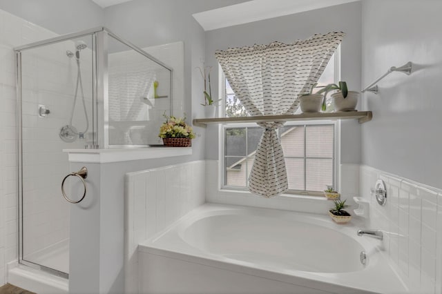 full bath featuring a shower stall and a bath