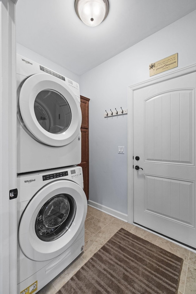 4801 Beryl Dr, Murfreesboro, TN 37128 - washroom featuring stacked washer / drying machine, cabinet space, light tile patterned floors, and baseboards