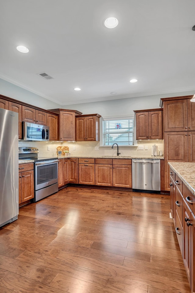 4801 Beryl Dr, Murfreesboro, TN 37128 - kitchen with appliances with stainless steel finishes, backsplash, light stone counters, dark wood-type flooring, and recessed lighting