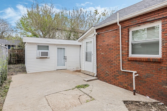 1607 Wheless St, Nashville, TN 37208 - property entrance featuring a patio, brick siding, fence, and roof with shingles