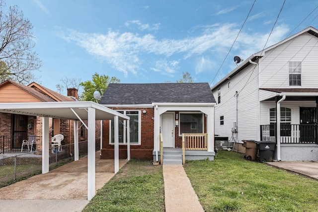 1607 Wheless St, Nashville, TN 37208 - view of front of house featuring brick siding, a carport, and a shingled roof