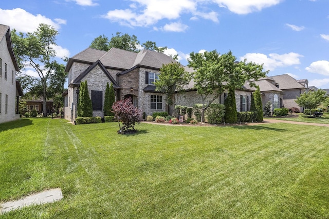 2979 Stewart Campbell Pt, Spring Hill, TN 37174 - french country style house featuring a front yard, stone siding, and brick siding
