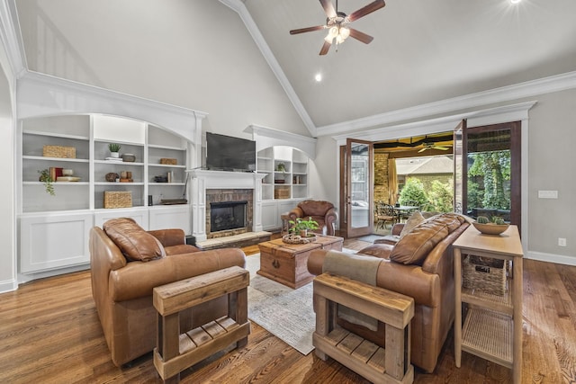 2979 Stewart Campbell Pt, Spring Hill, TN 37174 - living area featuring a ceiling fan, crown molding, high vaulted ceiling, a stone fireplace, and wood finished floors