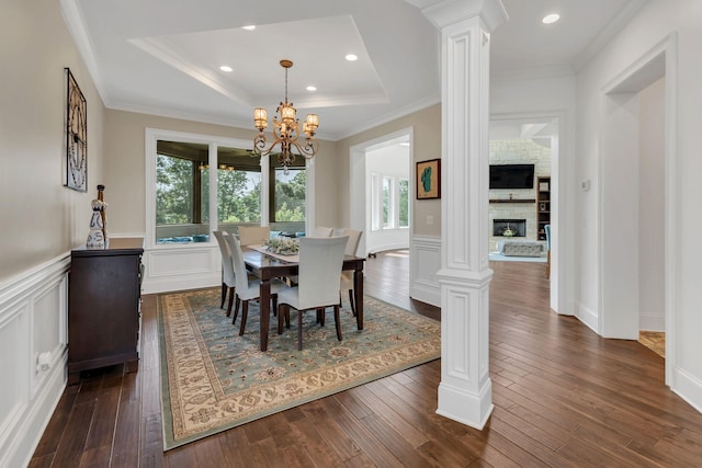 1477 S Harpeth Rd, Kingston Springs, TN 37082 - dining area featuring ornate columns, dark wood-type flooring, a chandelier, a raised ceiling, and a wainscoted wall