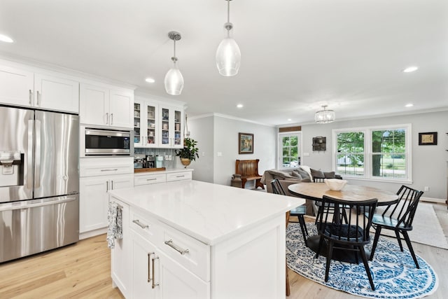 8757 Horton Hwy, College Grove, TN 37046 - kitchen featuring stainless steel appliances, ornamental molding, recessed lighting, light wood-style flooring, and white cabinetry