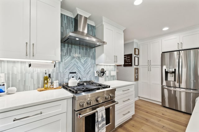 8757 Horton Hwy, College Grove, TN 37046 - kitchen with appliances with stainless steel finishes, wall chimney exhaust hood, light countertops, decorative backsplash, and white cabinets