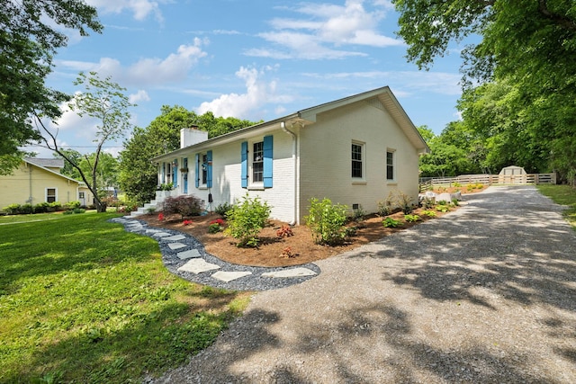 8757 Horton Hwy, College Grove, TN 37046 - ranch-style house with a chimney, brick siding, and a front lawn