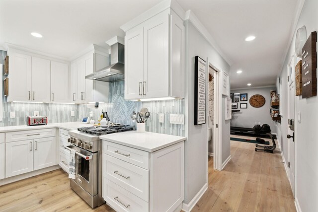 8757 Horton Hwy, College Grove, TN 37046 - kitchen featuring wall chimney range hood, high end stainless steel range, decorative backsplash, recessed lighting, and white cabinets