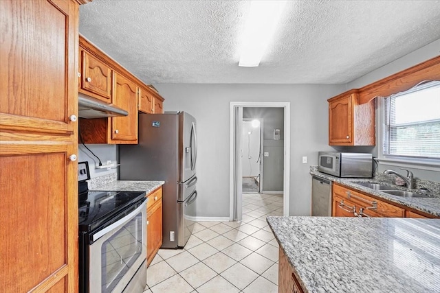 1306 Cason Trl, Murfreesboro, TN 37128 - kitchen featuring stainless steel appliances, under cabinet range hood, a sink, light tile patterned floors, and a textured ceiling