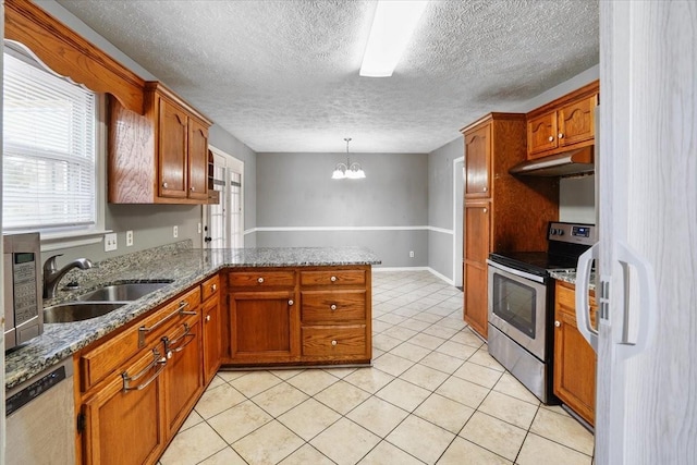 1306 Cason Trl, Murfreesboro, TN 37128 - kitchen with appliances with stainless steel finishes, a sink, a peninsula, brown cabinetry, and a textured ceiling