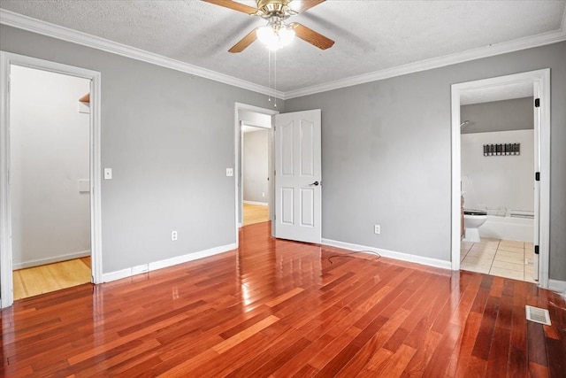 1306 Cason Trl, Murfreesboro, TN 37128 - unfurnished bedroom featuring wood finished floors, a textured ceiling, baseboards, crown molding, and ceiling fan