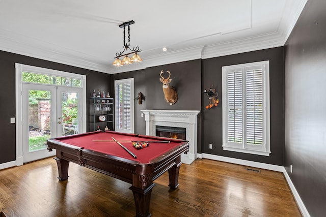 rec room with a lit fireplace, french doors, crown molding, wood finished floors, and baseboards