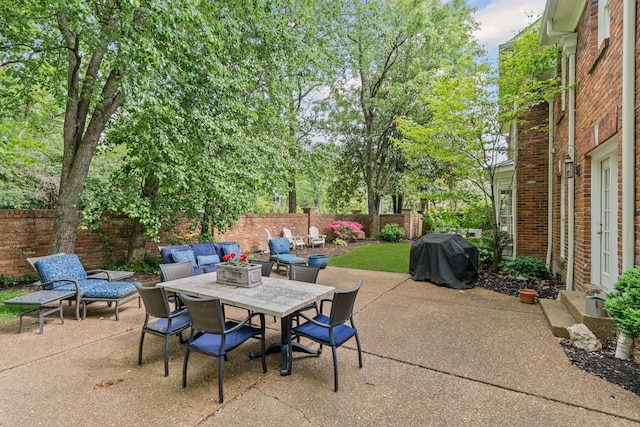 view of patio / terrace with a grill, a fenced backyard, and outdoor dining space