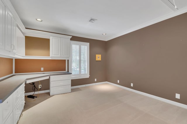 unfurnished office with built in desk, light carpet, baseboards, ornamental molding, and recessed lighting
