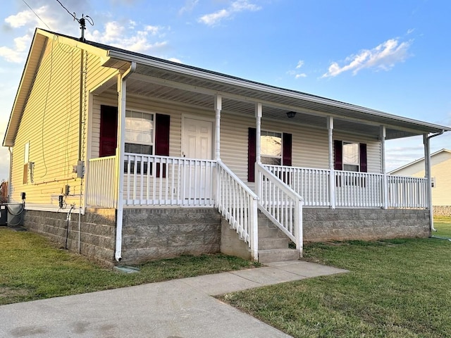 202 Jenna Ave, Oak Grove, KY 42262 - view of front of home with a porch, a front lawn, and central AC unit