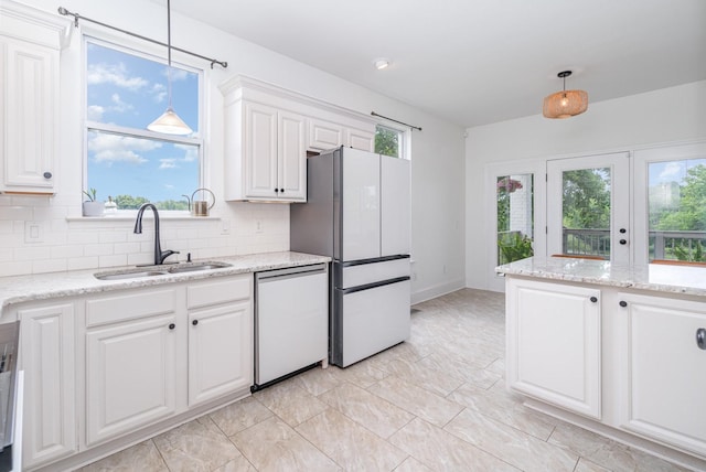 4851 Bethesda Duplex Rd, College Grove, TN 37046 - kitchen featuring a sink, freestanding refrigerator, stainless steel dishwasher, and decorative backsplash