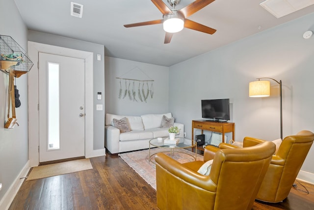 living area with wood finished floors, baseboards, and ceiling fan
