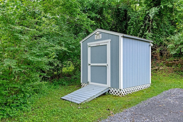 view of shed with a wooded view