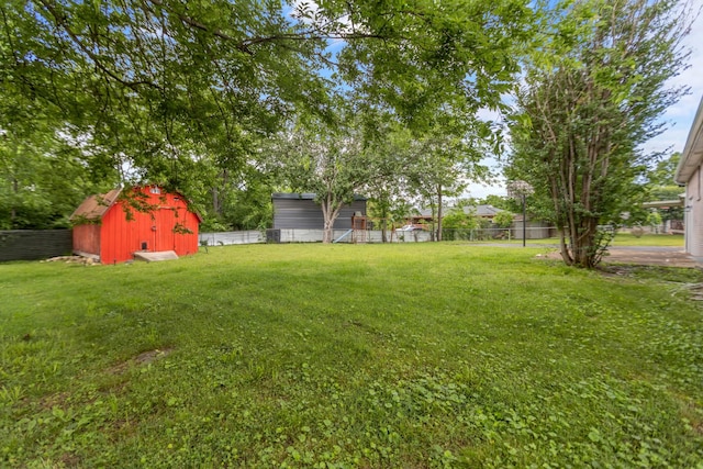 view of yard featuring a storage shed and an outbuilding