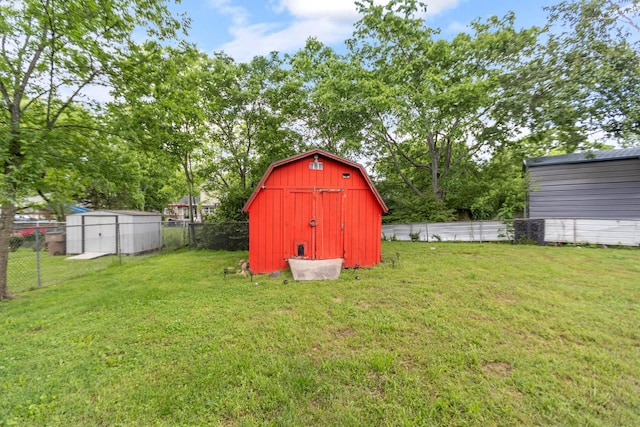 view of yard featuring a shed and an outbuilding