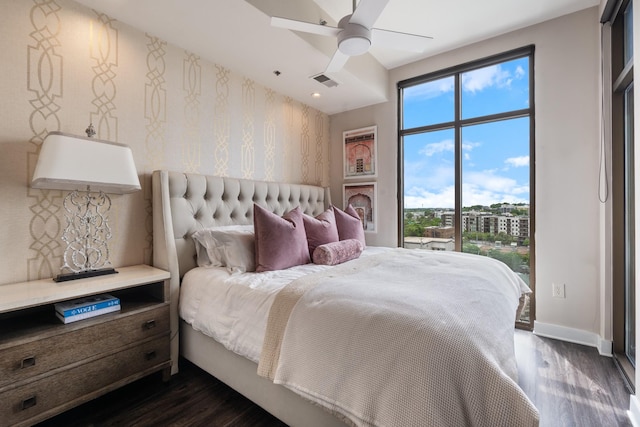 1510 Demonbreun St Unit 1012, Nashville, TN 37203 - bedroom featuring dark wood-style flooring, multiple windows, baseboards, wallpapered walls, and a ceiling fan