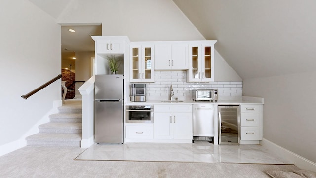 203 W Chandler Ct, Mount Juliet, TN 37122 - kitchen featuring appliances with stainless steel finishes, beverage cooler, lofted ceiling, a sink, and white cabinetry