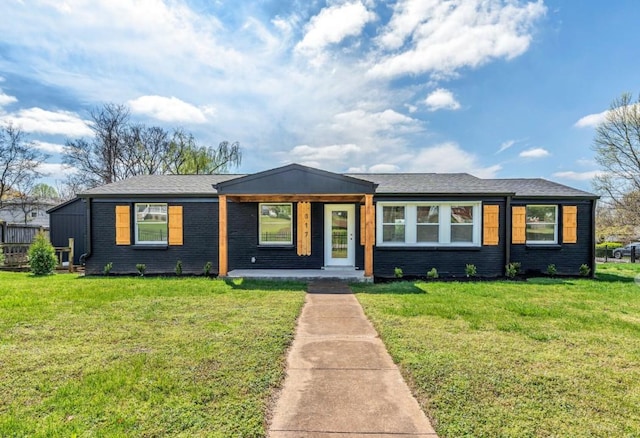 ranch-style house with a front yard and brick siding