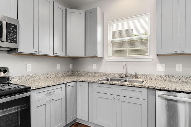 201 Hayes St, Smithville, TN 37166 - kitchen featuring appliances with stainless steel finishes, a sink, and light stone countertops